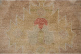Cinnabar red blossom on wheat beige pile of a hand-knotted Indian Oushak rug.