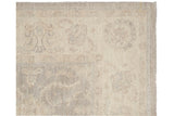 Subtle silver and ivory geometric tone-on-tone pattern on the Peshawar carpet pile.