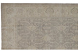 Peshawar carpet close-up with tone-on-tone shield medallions in silver and ivory.