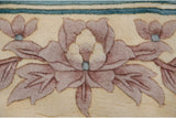 Shallow carved mauve floral bouquet with sky blue detail on Chinese Art Deco rug.