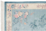 Shallow carved contour of sky blue and ivory floral motifs on this Art Deco rug corner.