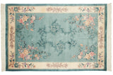 Close-up of Chinese Art Deco rug's shadow medallion, tone-on-tone blue floral bouquets.
