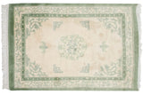 Vintage Indian Peking rug corner, moss green border, pearl, and butterfly motifs.