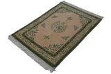 Vintage Indian Peking rug corner shows ivory fringe, moss green butterfly border, and field bat motif.