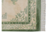 Vintage Indian Peking rug corner, showing moss green main border, butterfly motifs, and intact fringe.