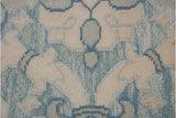 Ivory piled floral motif and powder blue Soumac weave texture on Indian contemporary carpet.