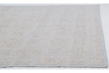 Raised ivory and pale blue roundel medallions on the Indian Soumac design carpet.