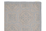 Contemporary Indian Soumac rug corner with raised ivory roundel pattern and intact selvage.