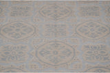 Ivory roundel medallions on powder blue, displaying low profile three-dimensional texture.