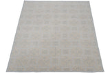 Textured roundel medallions in pale powder blue and ivory on an Indian Soumac carpet.