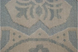 Three-dimensional texture of piled ivory and pale blue Soumac weave.