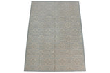 Corner close-up of pale powder blue and ivory roundel medallions with subtle texture.
