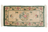 Ivory vintage Peking rug: pictorial vase, blossoms, fruit, dusty green border. 2' x 4'.
