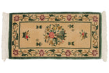 Pictorial Peking rug scene with blossoming vase, raspberry red blossoms, and scattered fruit.