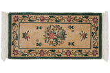 Corner of Peking runner: ivory field, raspberry floral border, dusty forest green edge, fringe.