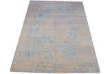 Section of modern Indian Persian rug featuring distressed beige and blue aquatic pattern.