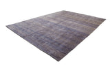 Modern Indian carpet featuring textured abstract pattern in blended blues, ink, and ivory.