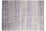 Intricate alternating patterns of the Indian Modern carpet in ivory and varied blue hues.