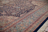 Intricate navy floral field with contrasting sky blue border on the vintage Ardebil rug.
