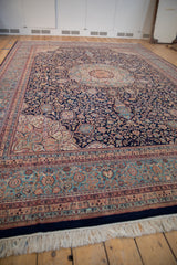 Vintage Indian Ardebil carpet: navy field, thousand flower motif, sky blue spandrel.