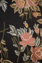 Close-up of the hand woven chainstitch texture with rose, copper, and blue floral details.