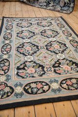 Vintage chainstitch rug with oblong floral panels set within a dusty powder blue border.