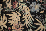 Detailed view of the spiraling chainstitch weave creating curvilinear botanical patterns.