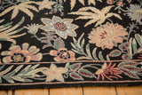 Detailed chainstitch weave of a floral border in dusty rose and green against a black background.