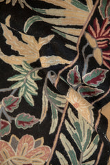 Detailed texture of the chainstitch weave, showing curvilinear leaves in beige, green, and burgundy.