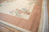 Art Deco carpet's shallow carved floral motif and color transition at border.