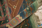 Vintage Indian Caucasian design carpet, plush pile, fringe with light green tones, and geometric patterns.