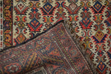 The dense, hand-knotted foundation and textured wool pile of a vintage Persian Hamadan rug.