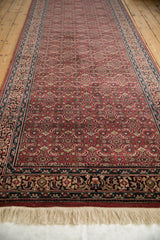 Hand-knotted fringe and Herati mahi-mahi design on a red Indian Bijar rug.