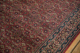 Dark cochineal red Indian Bijar rug field and navy border with Herati floral details.
