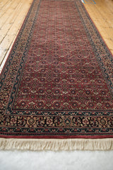 Ivory fringe and detailed floral mahi-mahi border of the Indian Bijar runner.