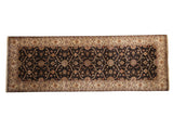 Mogul rug runner with a charcoal trellis design of medallions and leaves, set within a wide, sand-colored border.