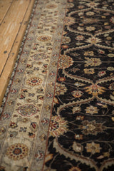Intact side cord selvage on a Mogul runner separates the sand-colored border from the dark charcoal trellis field.