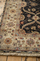 Angled close-up of the Mogul rug runner's corner, showing the sand-colored border and charcoal field.