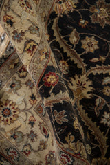 High sheen on the dense wool pile of a Mogul rug with charcoal and sand trellis design motifs.