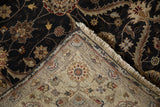 Mogul rug corner folded to contrast the dense wool pile with its clean hand-knotted back.