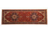 Indian Heriz design rug runner with double navy medallions on a brick red field and a classic turtle border.