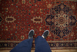 Looking down at the Indian Heriz rug runner's rich brick red and navy blue geometric pattern.