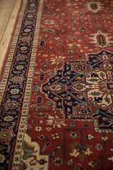 Angled view of the plush pile on a Heriz runner, with a navy turtle border next to a brick red field.