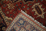 Corner of a Heriz runner showing the Samovar border, dense red pile, and hand-knotted back.