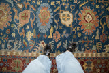 Indian Bijar carpet detail: sky blue field and dense floral arabesques in sandalwood, brick red.