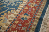 Harshang Bijar design detail: brick red border, sky blue field, floral arabesques, ivory fringe.