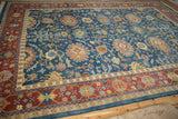 Detailed view of the brick red border and sky blue field's floral medallions and arabesques.