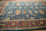Brick red border and sky blue field with floral arabesques on a vintage Bijar rug.