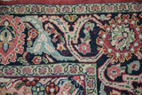 Detail of the main border's floral palmette design in rich gem-like tones on a vintage Arak carpet.
