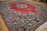 Corner detail of a vintage Arak carpet with a palmette and floral arabesque main border.